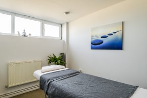 photography of the Bloom Holistic Health treatment room showing physiotherapy couch and window
